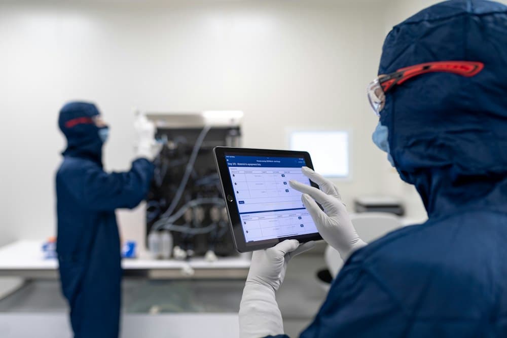 Team using process software on a computer screen in an industrial workplace